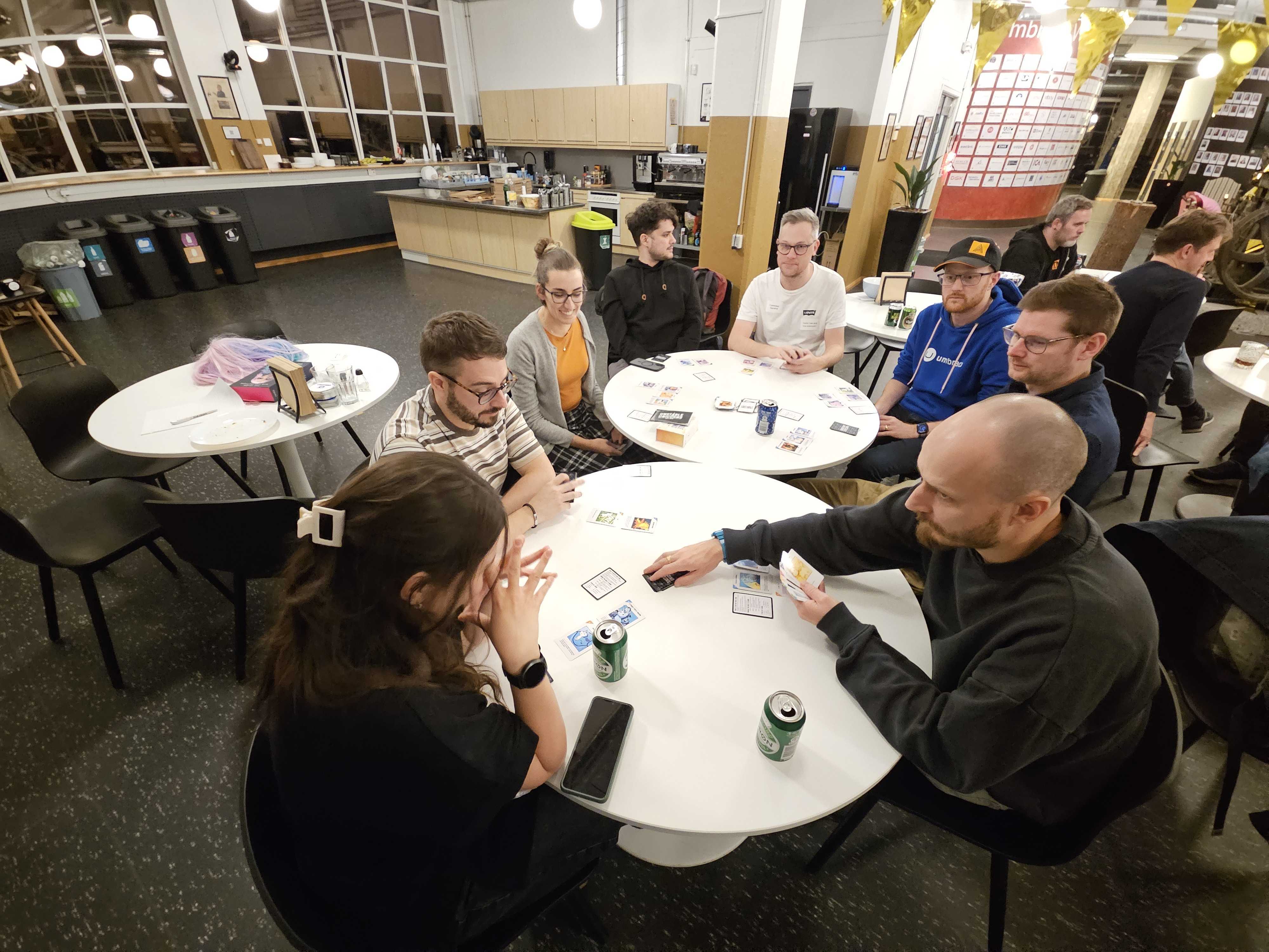 A happy group of people playing cards at Umbraco HQ