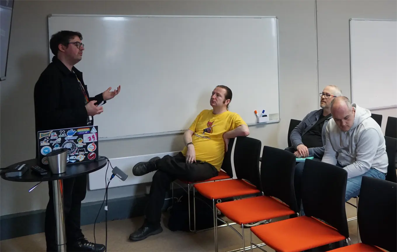 Terence Burridge at an event watching a talk by Richard Jackson