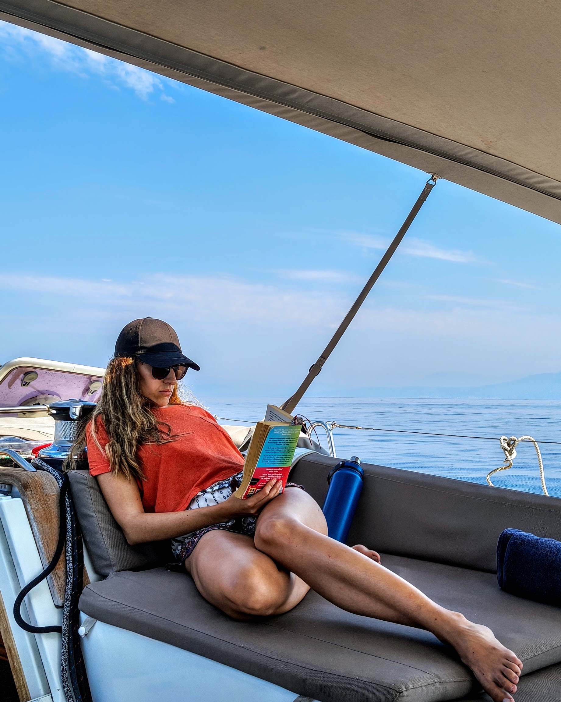Woman reading while sailing