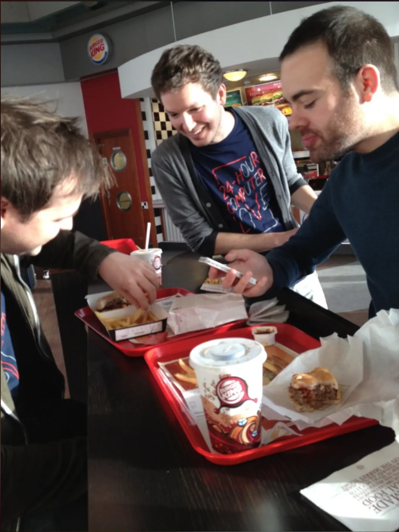 Three men eating food