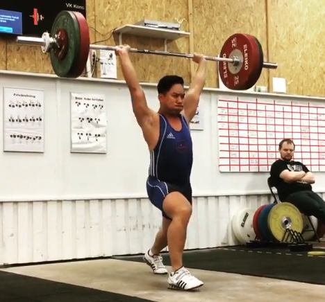 Thinh competing in Olympic weightlifting, successful lift.