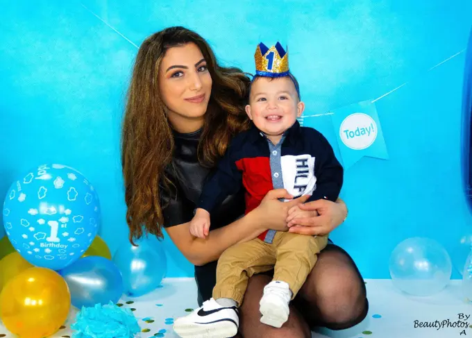 Nadia holding Adam on his birthday