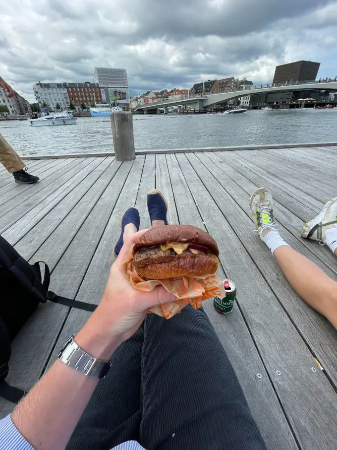 Emil holding a burger from POPL in Copenhagen