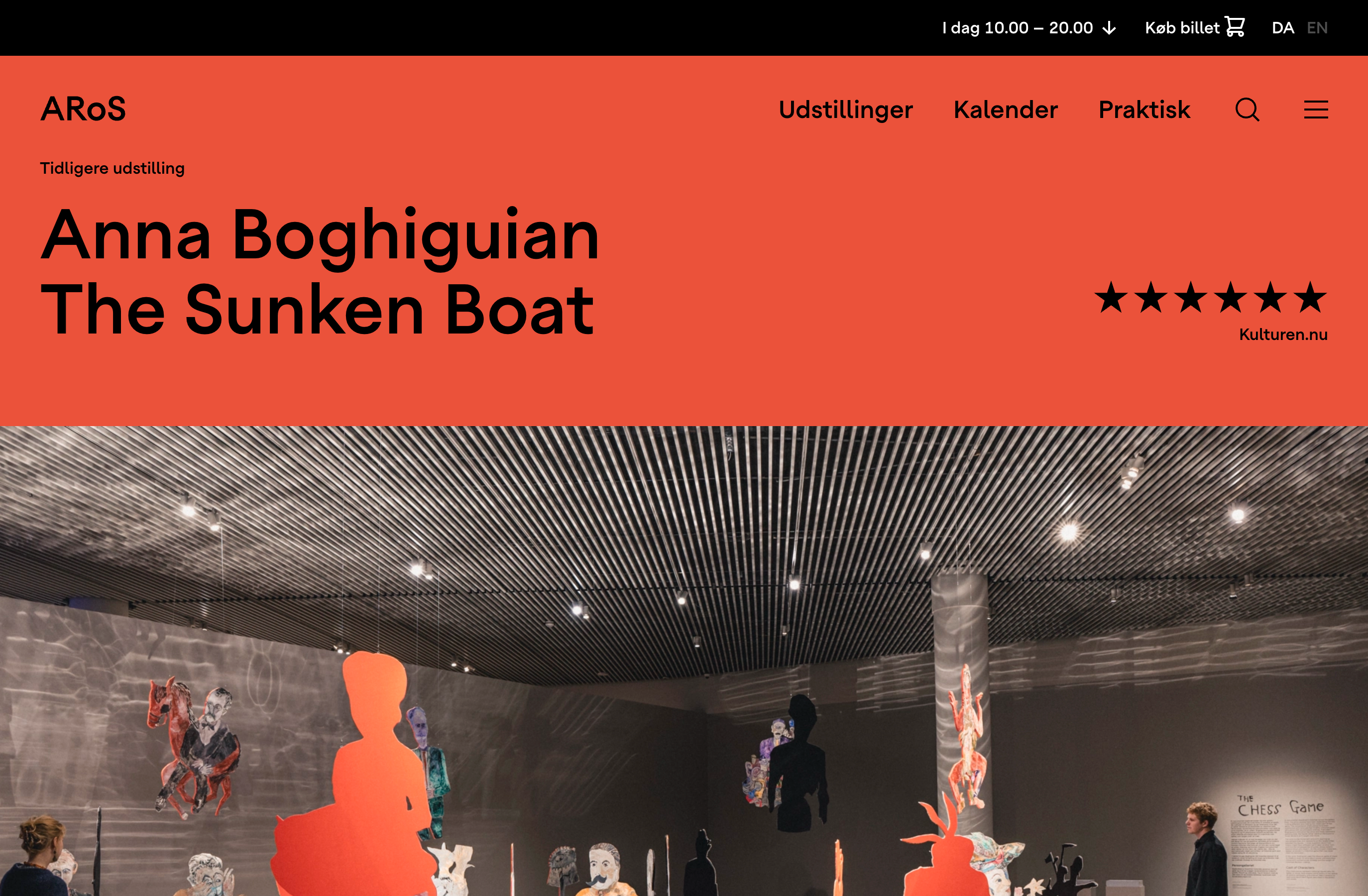ARoS website page for Anna Boghiguian's exhibition "The Sunken Boat" with a bright orange-red header, a six-star review from Kulturen.nu, and a gallery photo of painted cut-out figures hanging from the ceiling.