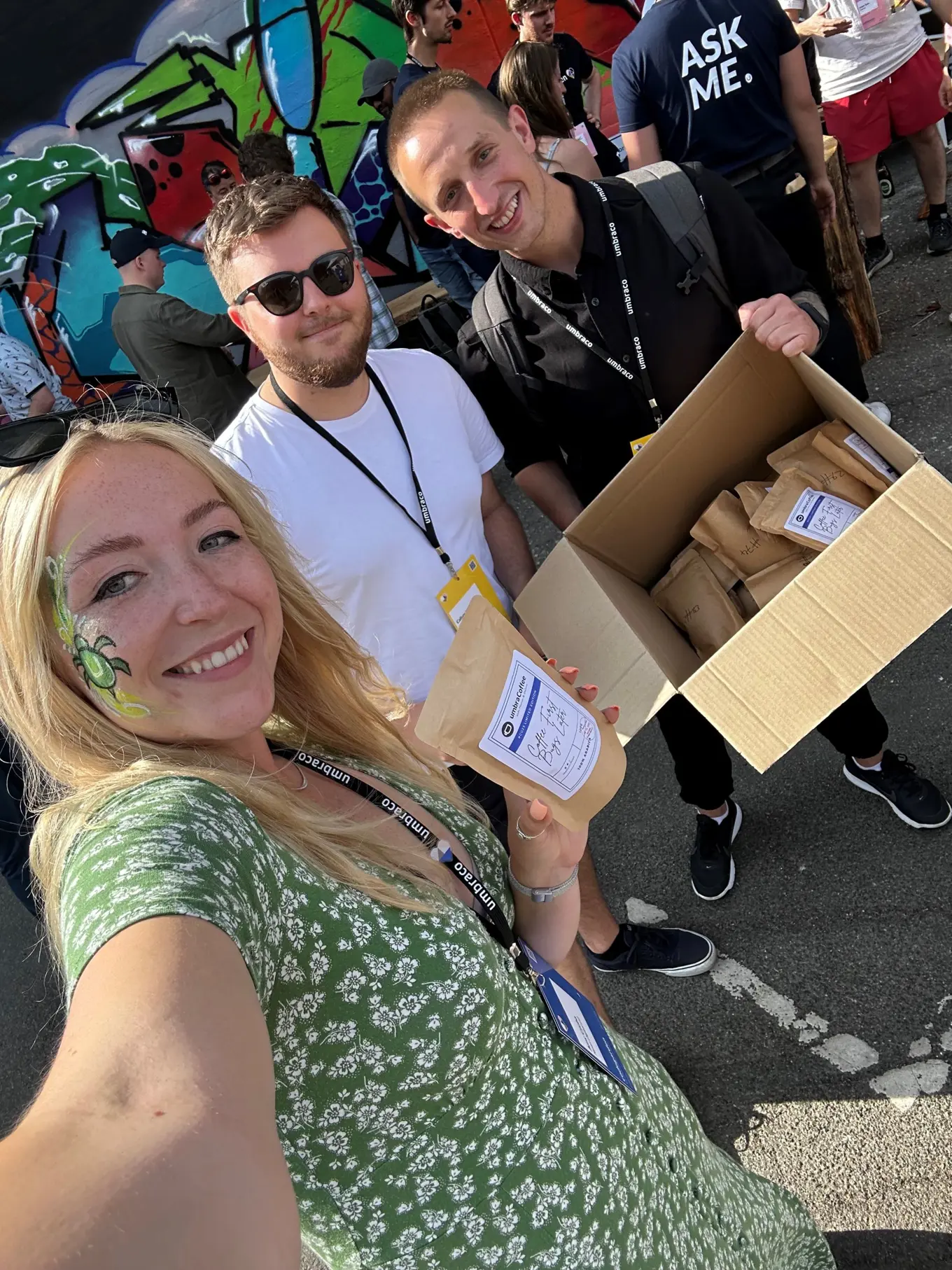 Amy Czuba with fellow Umbracians, Callum Whyte and Marcin Zajkowski, at Codegarden in Denmark, receiving her bag of free Umbracoffee coffee