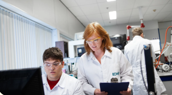 BEWI RAW laboratory research team collaborating on data analysis and product testing in a modern scientific facility.