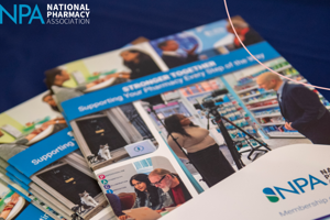Brochures on a table with National Pharmacy Association logo, including a “Supporting …” cover.
