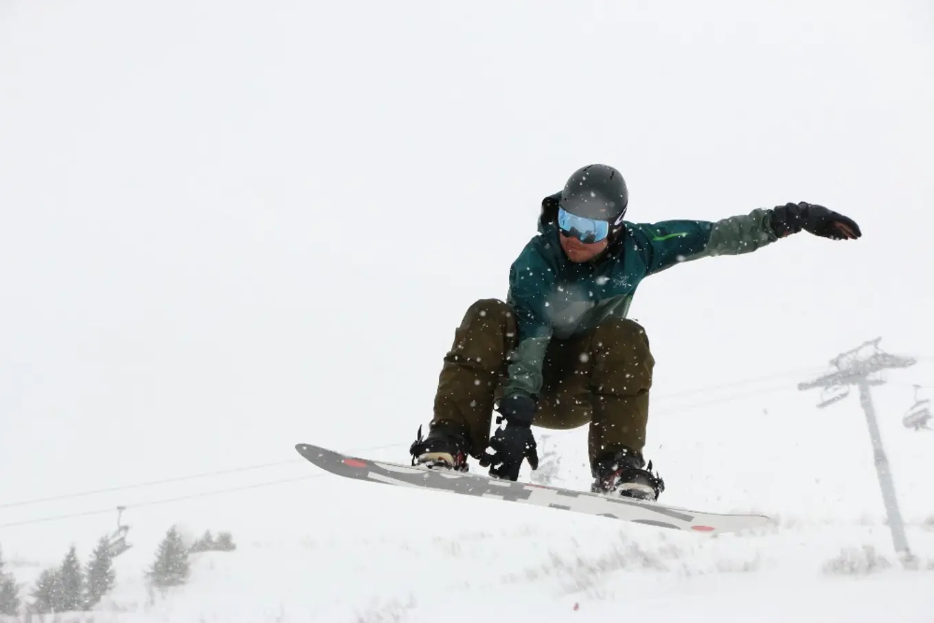 Paul doing a jump while snowboarding