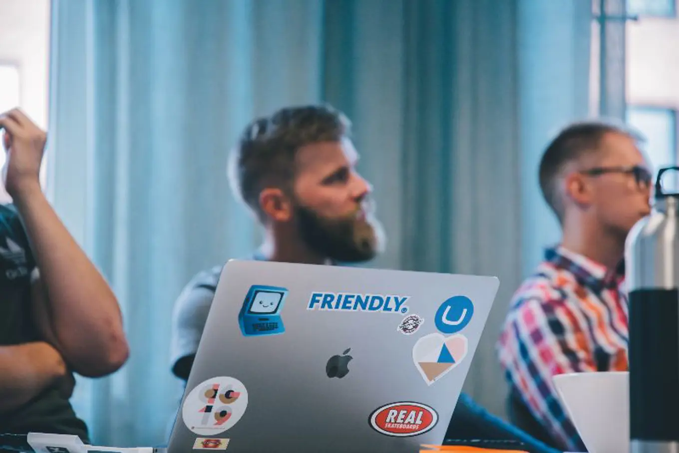 Toxic employees sitting at computer with a "Friendly" sticker