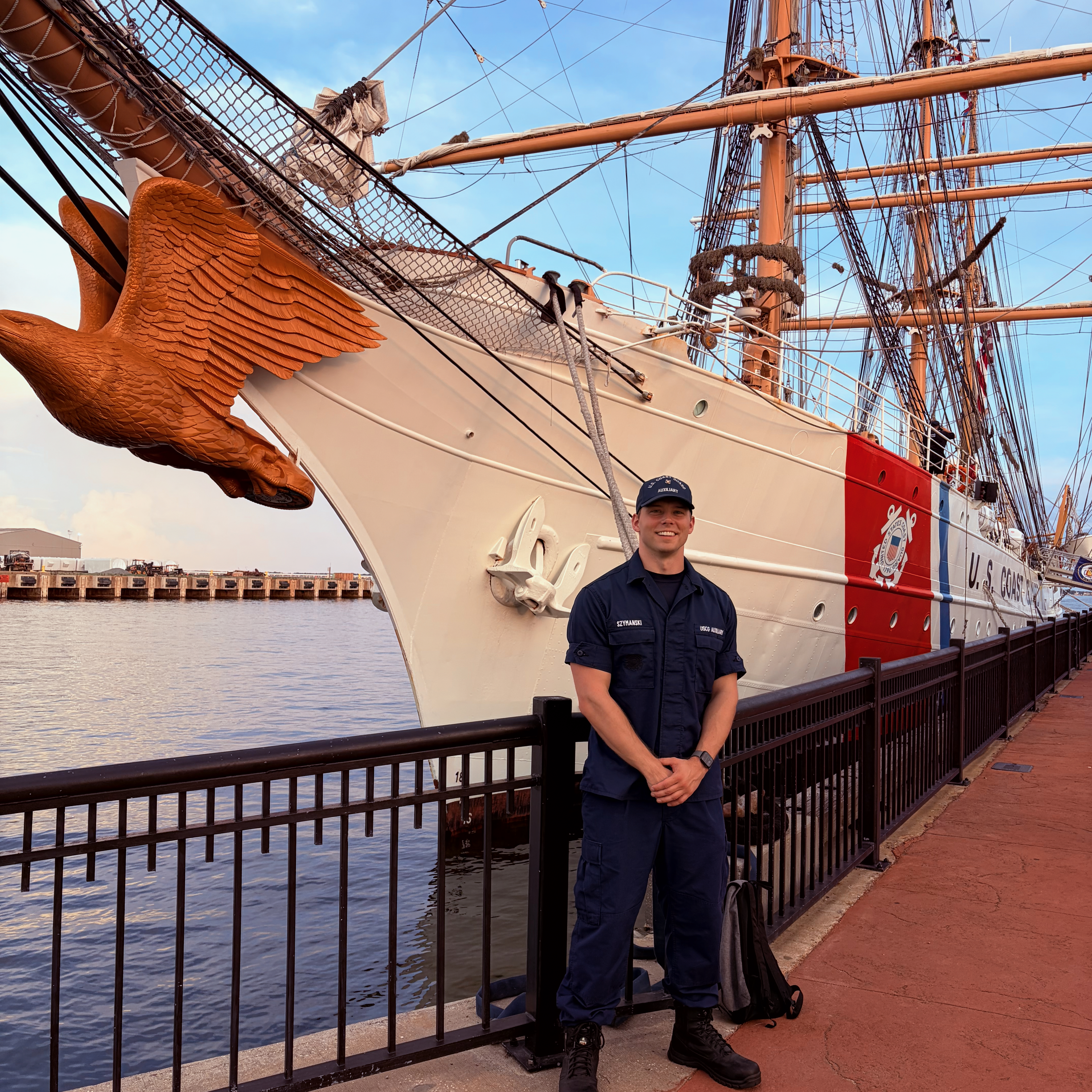 Ben standing in front of a boat 