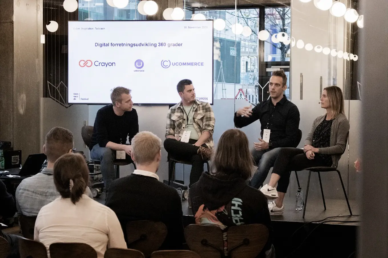 Bjarke, Arnold, Filip and Helle from HQ are sitting together on the stage. Filip speaks while the audience listens on