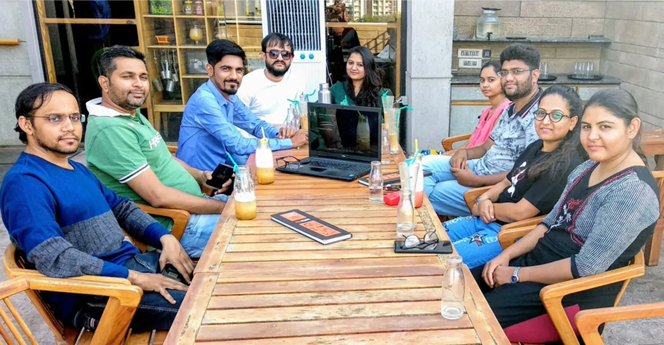 Attendees of the Ahmedabad meetup sit around a table