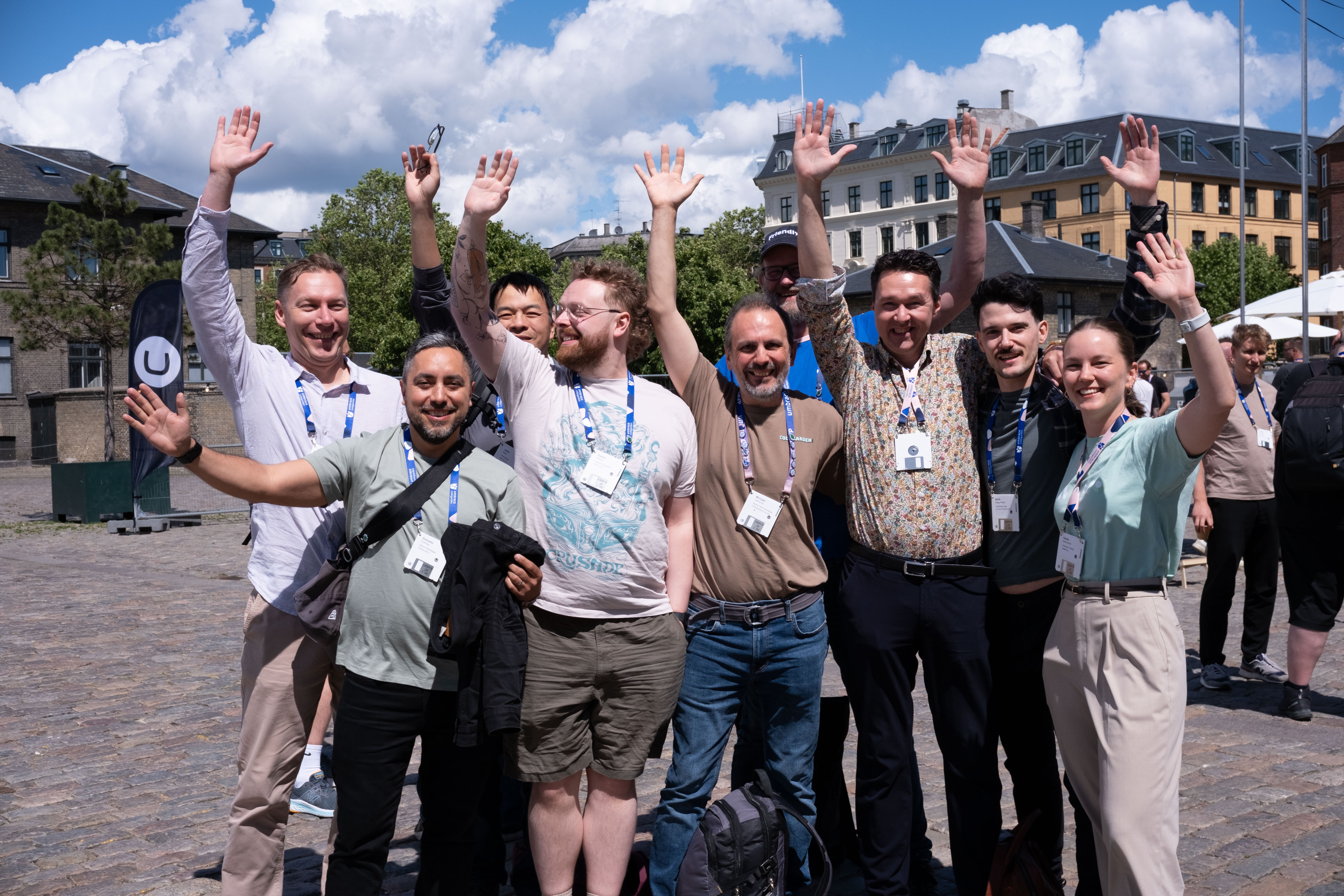 Happy Green Track travelers waving and posing together during the Codegarden conference