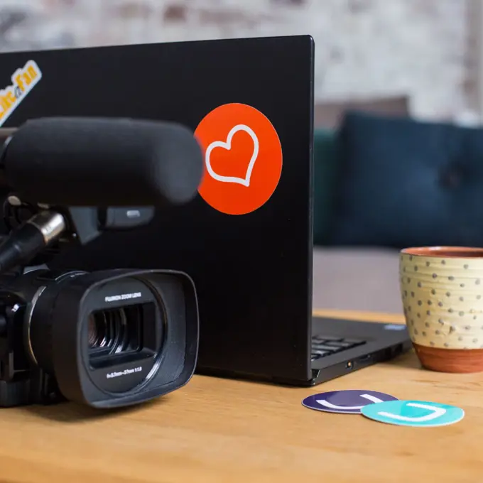 Video camera and a laptop with Umbraco branded stickers