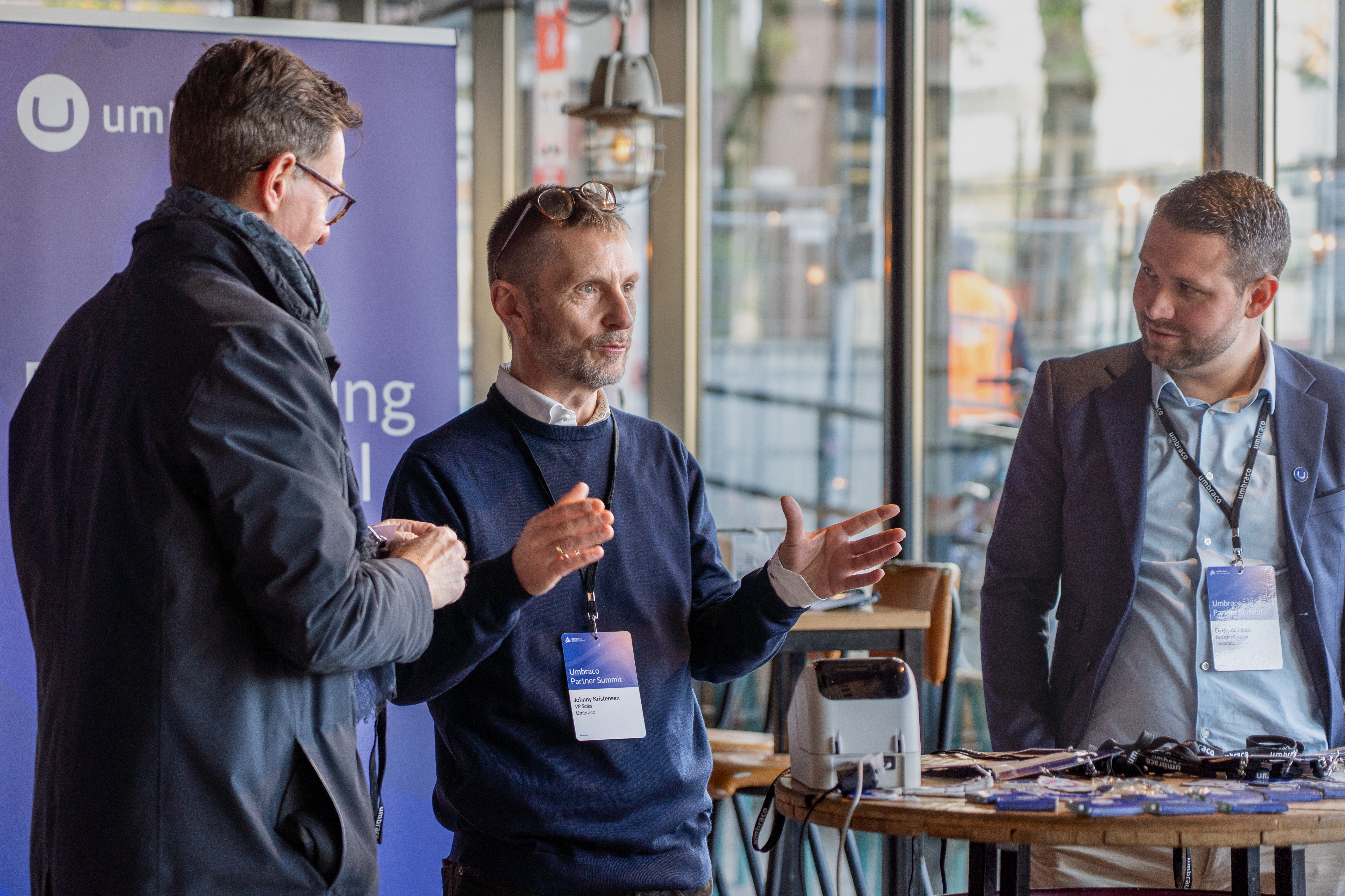 3 co-workers talking at an event