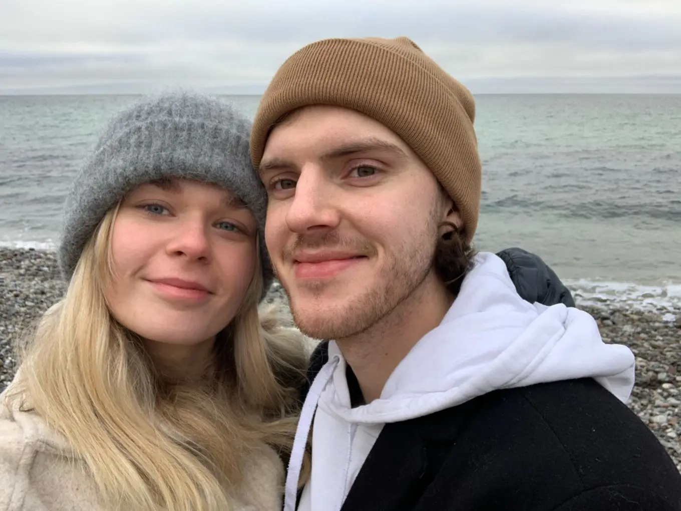 Andreas and his girlfriend in winter hats near the oceanYou know the handsome one on the right 😉