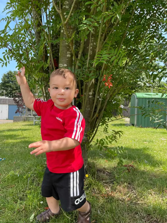 Adam standing under a tree