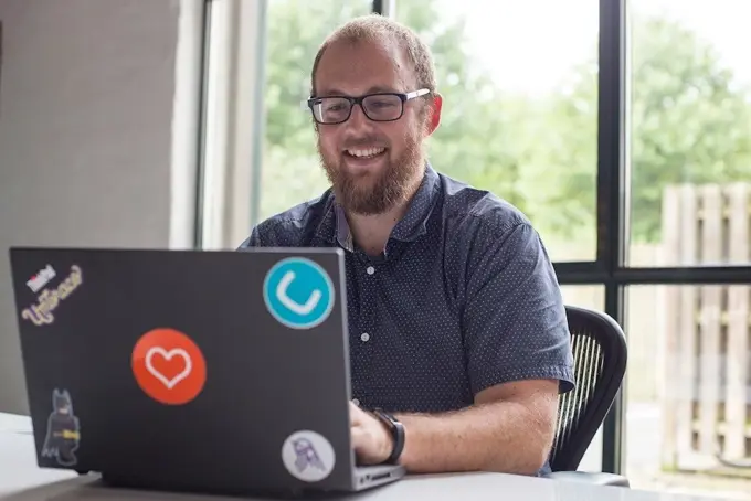 Happy person working on laptop