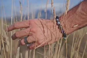 Hand with Shamballa Jewels ring and bracelet 