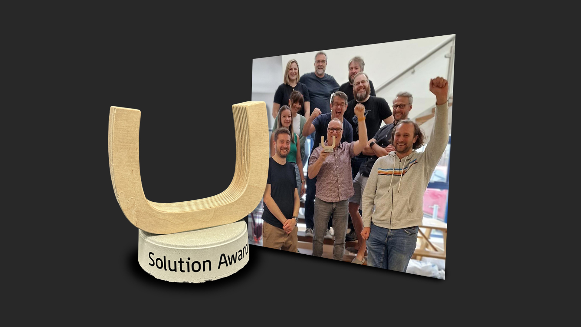 Golden award icon with “Solution Award” text beside a group cheering in an office photo