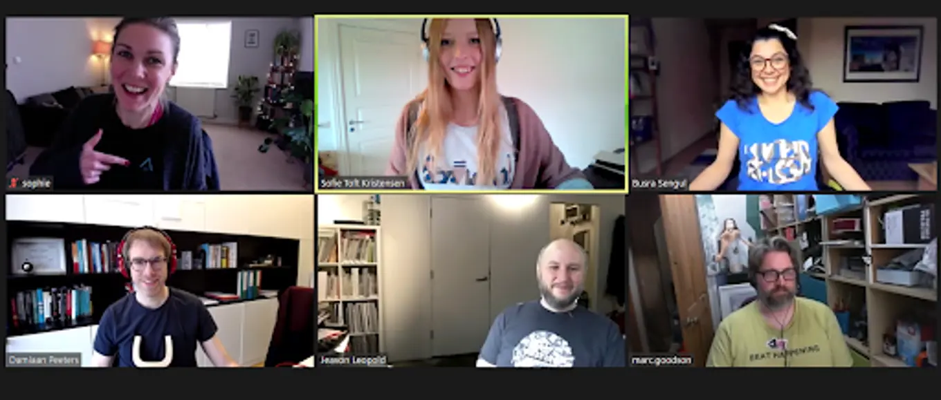 The Docs team are together on Zoom, smiling at the camera. Sophie, Sofie, Busra, Damiaan, Jeavon and Marc are all on camera in their Umbraco Tees