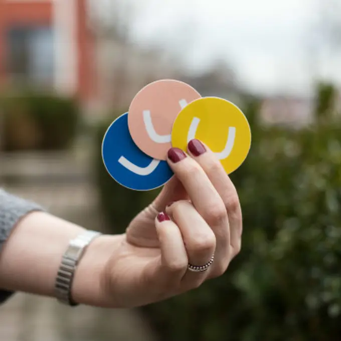 Umbraco logo trio on stickers held in hand