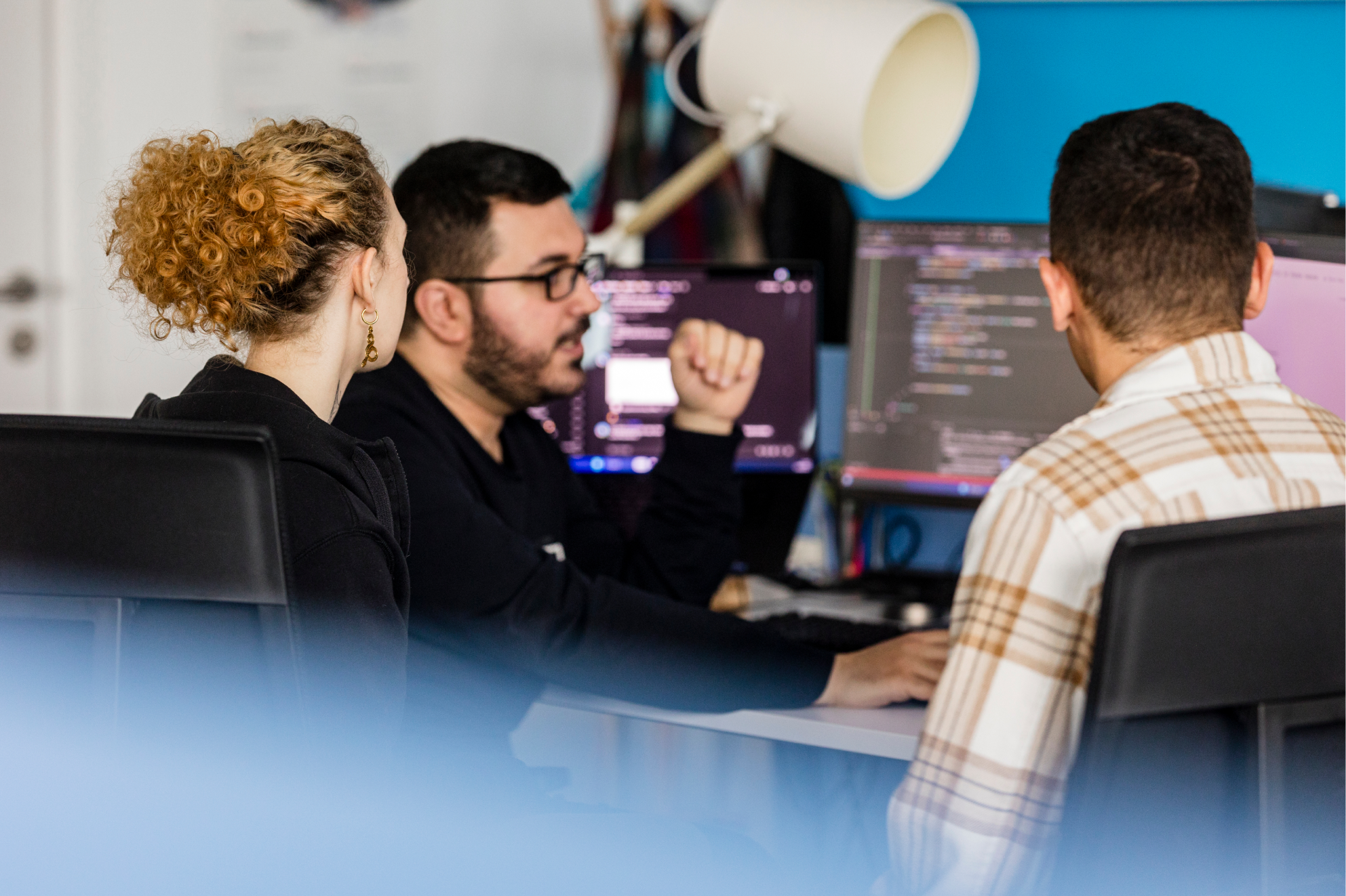 Software development team collaborating on custom web platforms at byte5 office workspace.