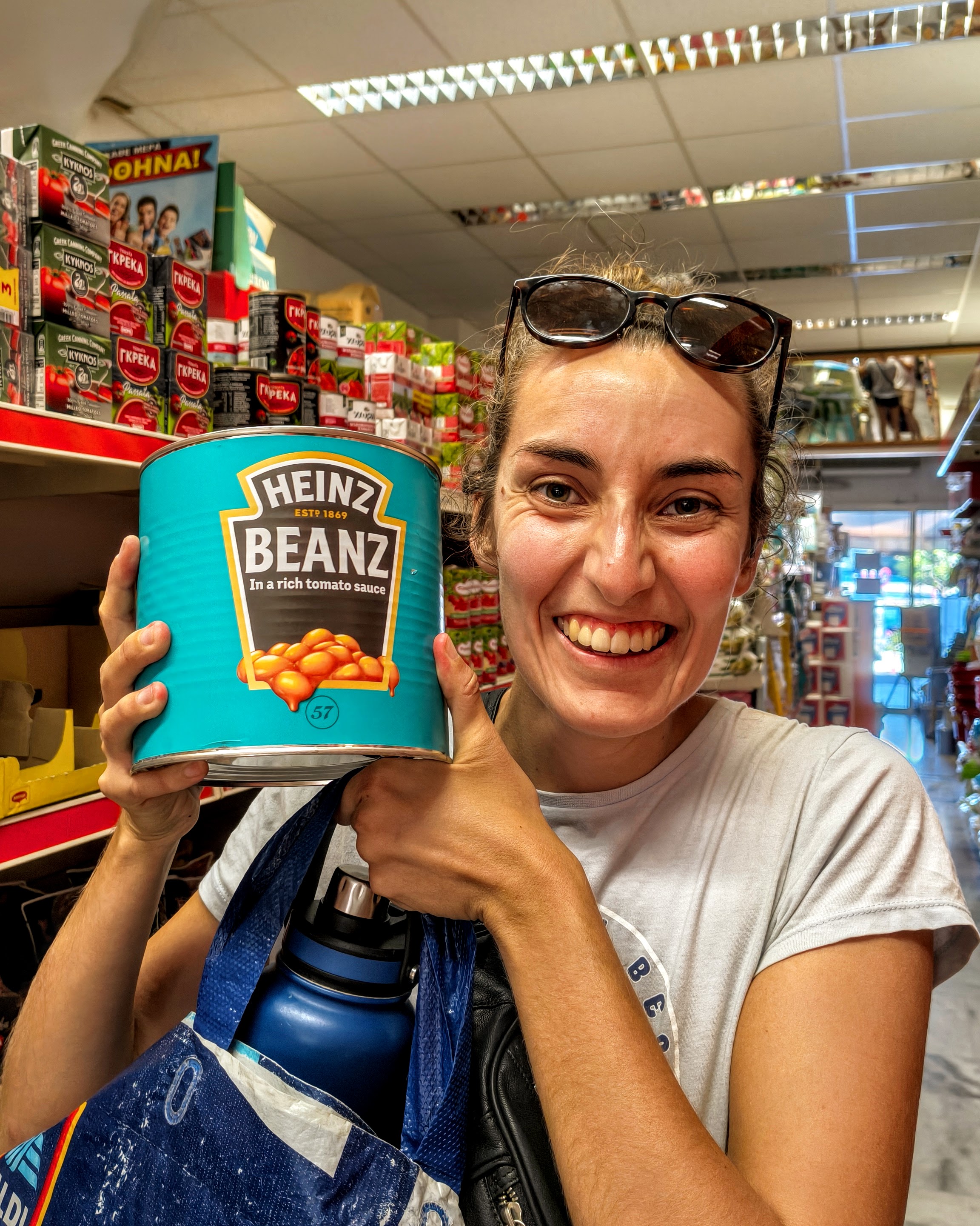 A woman holding a can of baked beans